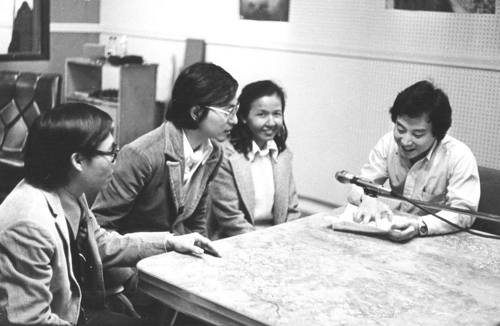 four adults at table