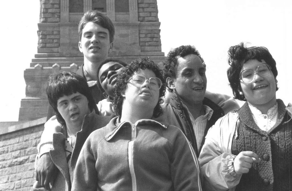 adults in front of statue of liberty