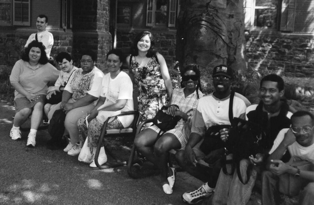 adults sitting on bench outside