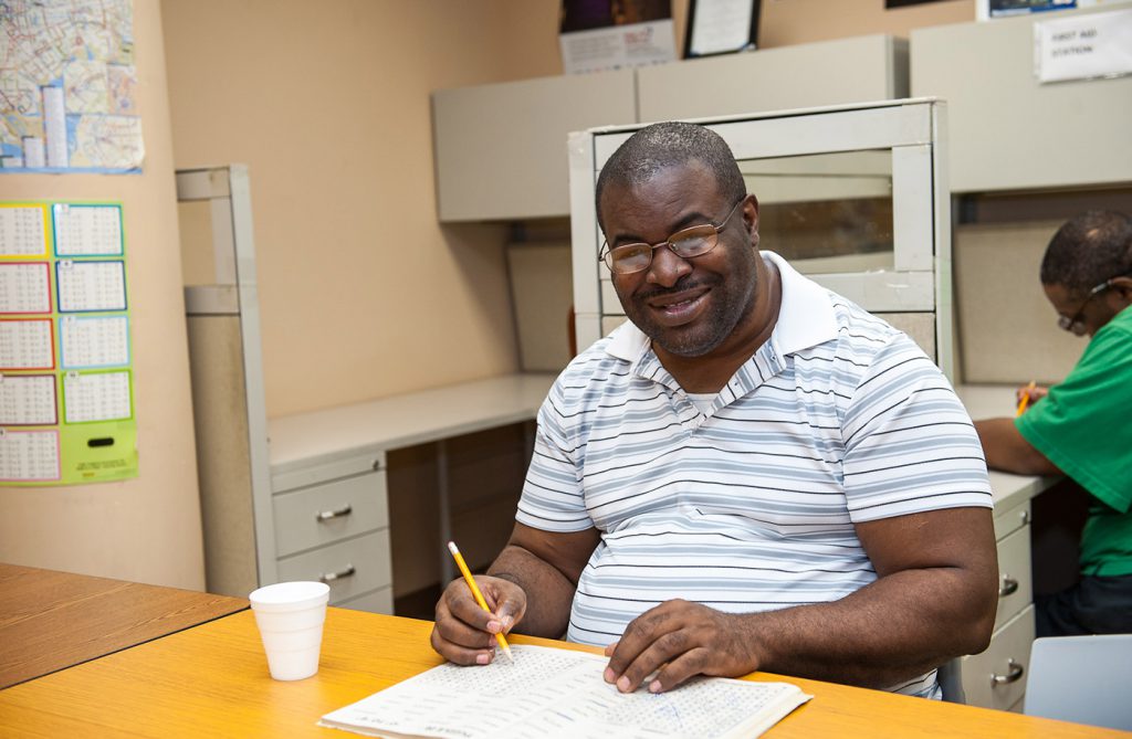 man writing at table