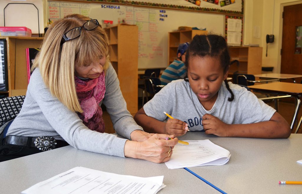 Teacher reviewing an assignment with a student.