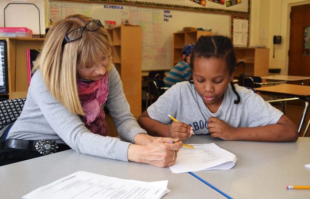 Teacher reviewing an assignment with a student.